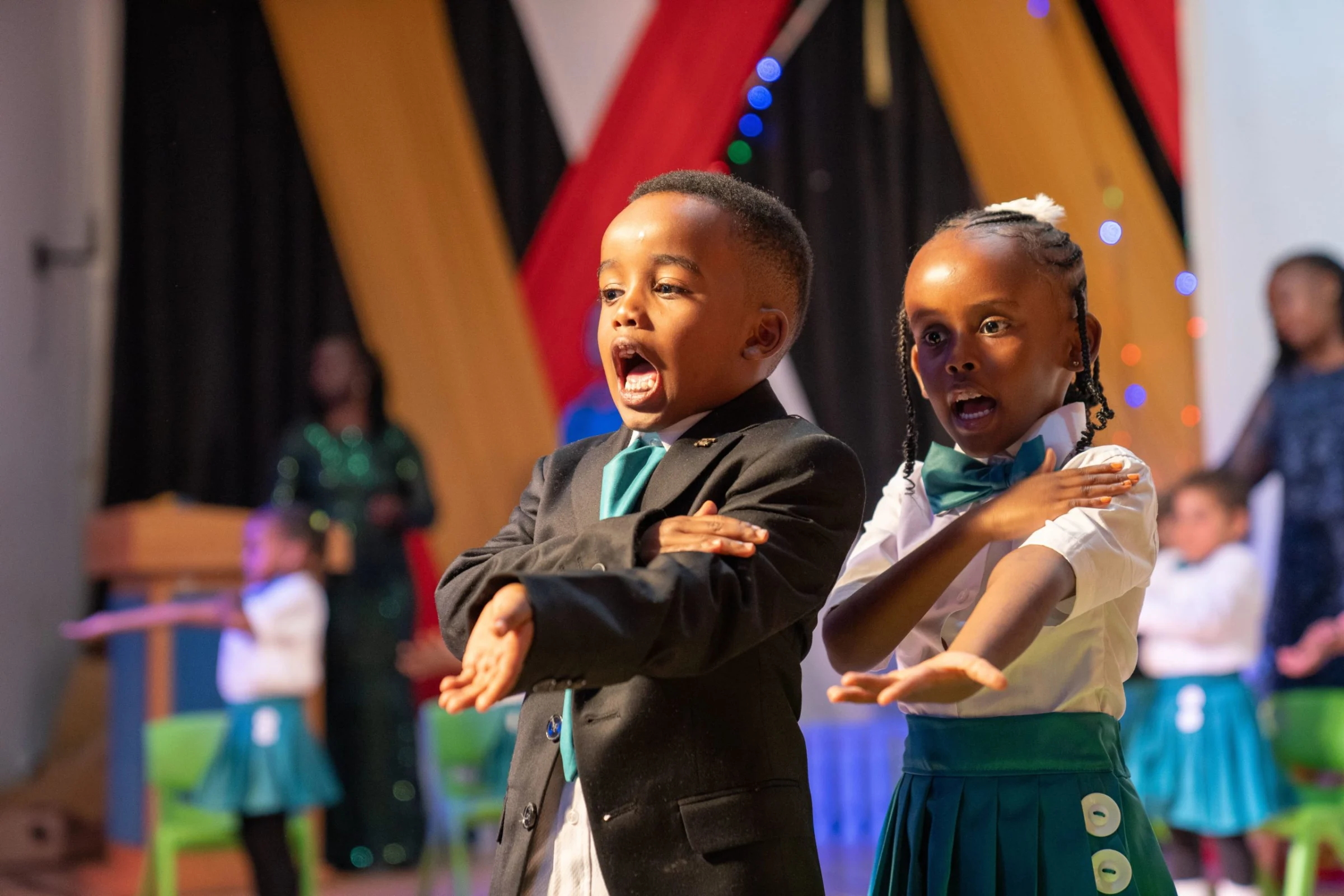 Learners performing on stage
