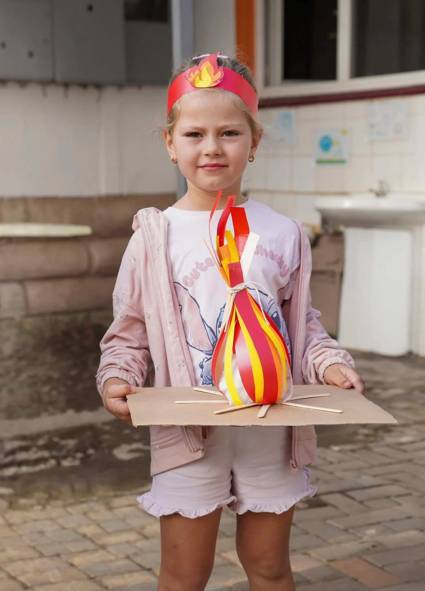 A learner with her paper bonfire model